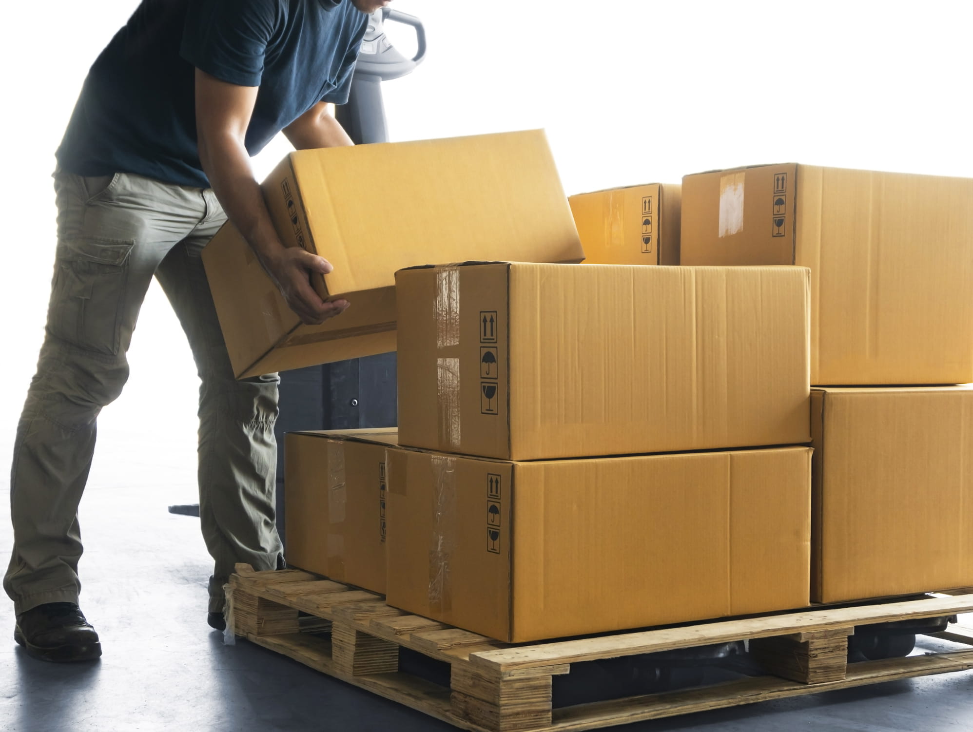 Worker moves boxes from a pallet